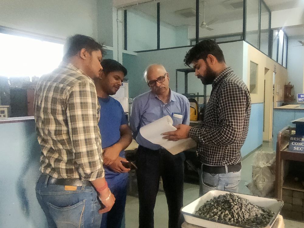 Engineers reviewing material test records at a testing laboratory