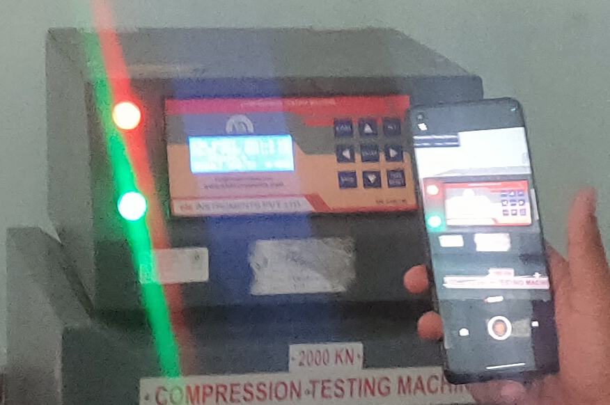 Concrete cube in a compression testing machine