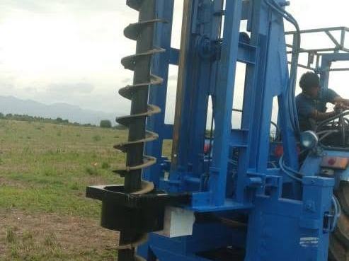 Tractor-mounted piling auger owned by Solunar
