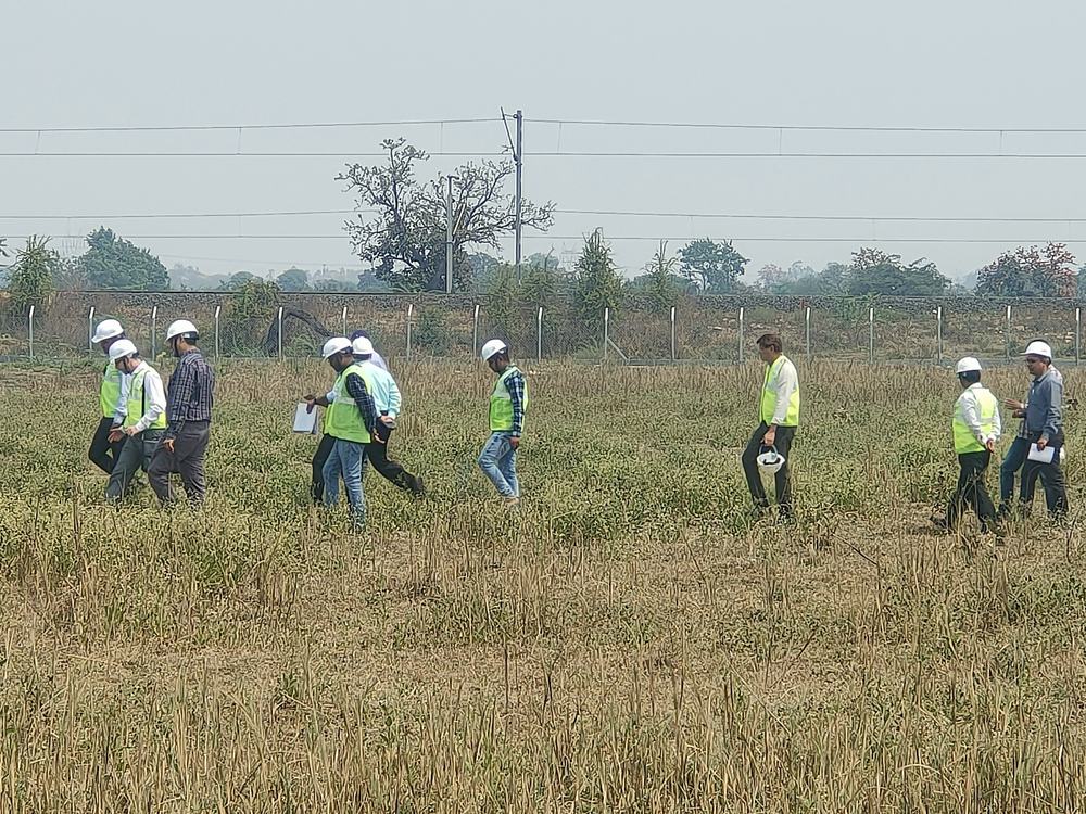 Engineers walking a solar site during inspection